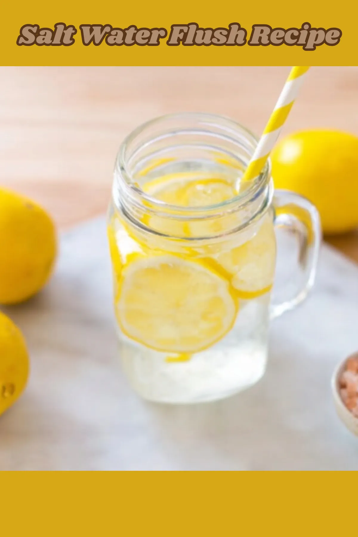 Salt water flush recipe in glass mason jar with lemon slices and yellow striped straw surrounded by fresh lemons on white surface