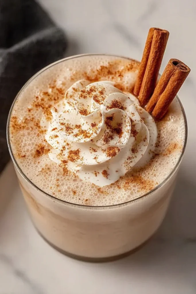 Iced Pumpkin Spice White Russian cocktail with whipped cream swirl