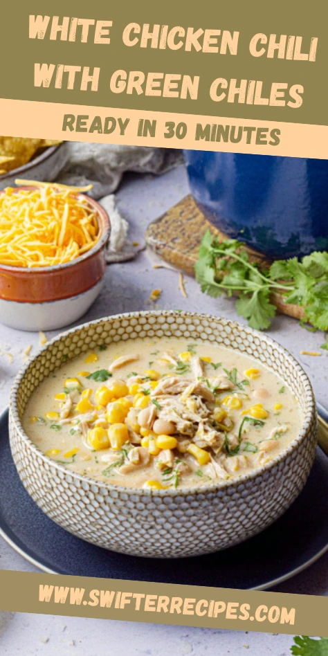 Bowl of White Chicken Chili with Green Chiles topped with corn, beans, and shredded chicken, served with cheese and fresh cilantro