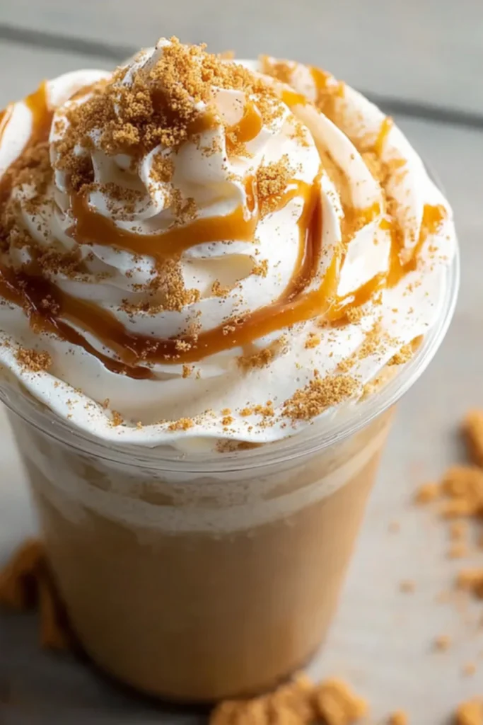 Top View of PSL Frappuccino with Whipped Cream, Caramel Drizzle, and Crumbled Cookies