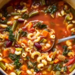 Italian Minestrone with Kale soup in a Dutch oven with pasta, beans, and vegetables in a rich tomato broth