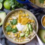 White Chicken Chili with Green Chiles topped with avocado, tortilla chips, cilantro, and sour cream