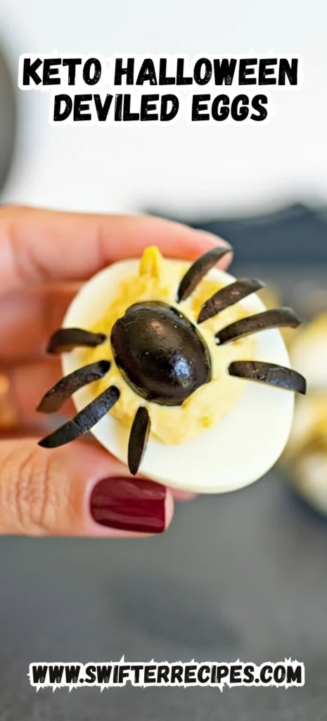 A hand holding a Keto Halloween Deviled Egg decorated with a black olive spider, perfect for Halloween parties.