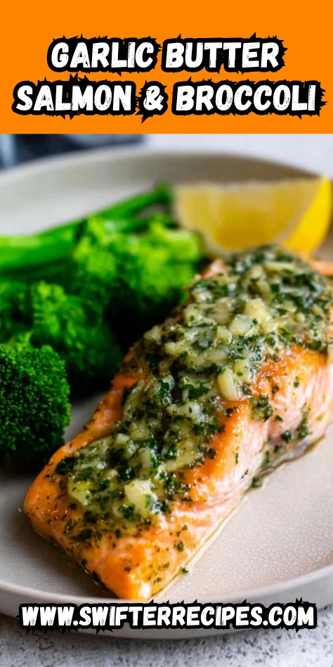 A close-up shot of garlic butter salmon topped with a savory mixture of garlic and herbs, served with fresh broccoli and a lemon wedge.