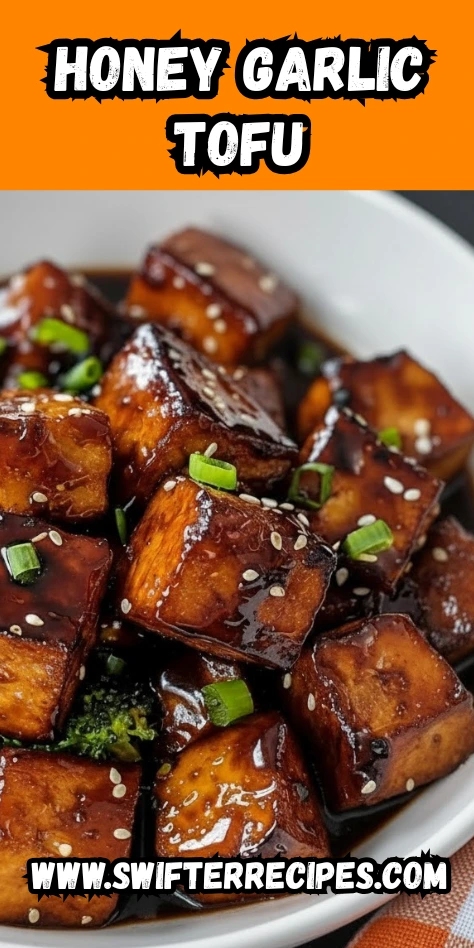 Crispy honey garlic tofu cubes glazed in sticky soy-honey sauce with sesame seeds and green onions served in a white bowl.