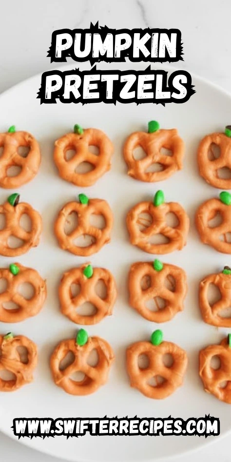 Pumpkin Pretzels on a white plate with green M&M stems and text overlay www.swifterrecipes.com festive Halloween snack idea for fall parties.
