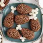 Plate of Rice Krispie Turkey Legs made with Cocoa Krispies, pretzel rods, and marshmallows shaped like drumsticks, perfect for Thanksgiving dessert.