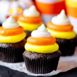 Candy Corn Cupcakes with vibrant yellow, orange, and white buttercream frosting on a moist chocolate base for a festive Halloween treat.