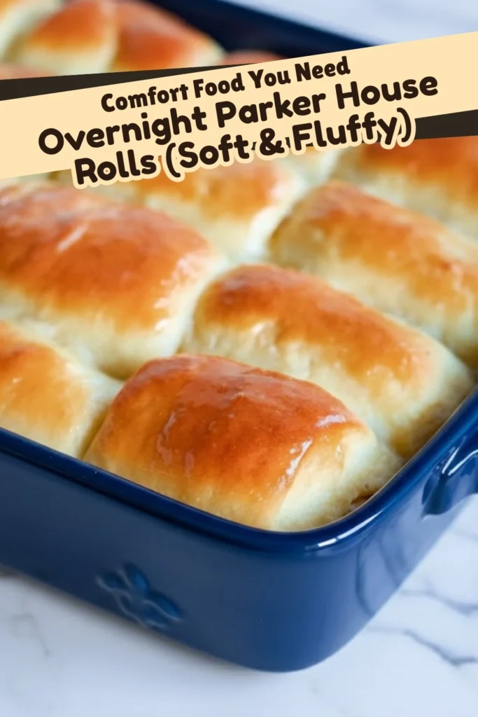 Overnight Parker House Rolls in a blue baking dish with soft golden tops.