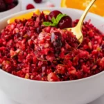 Fresh homemade cranberry relish with apples, oranges, and nuts served in a white bowl