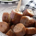 Chicken apple sausage appetizers coated in a maple mustard glaze served in a glass bowl