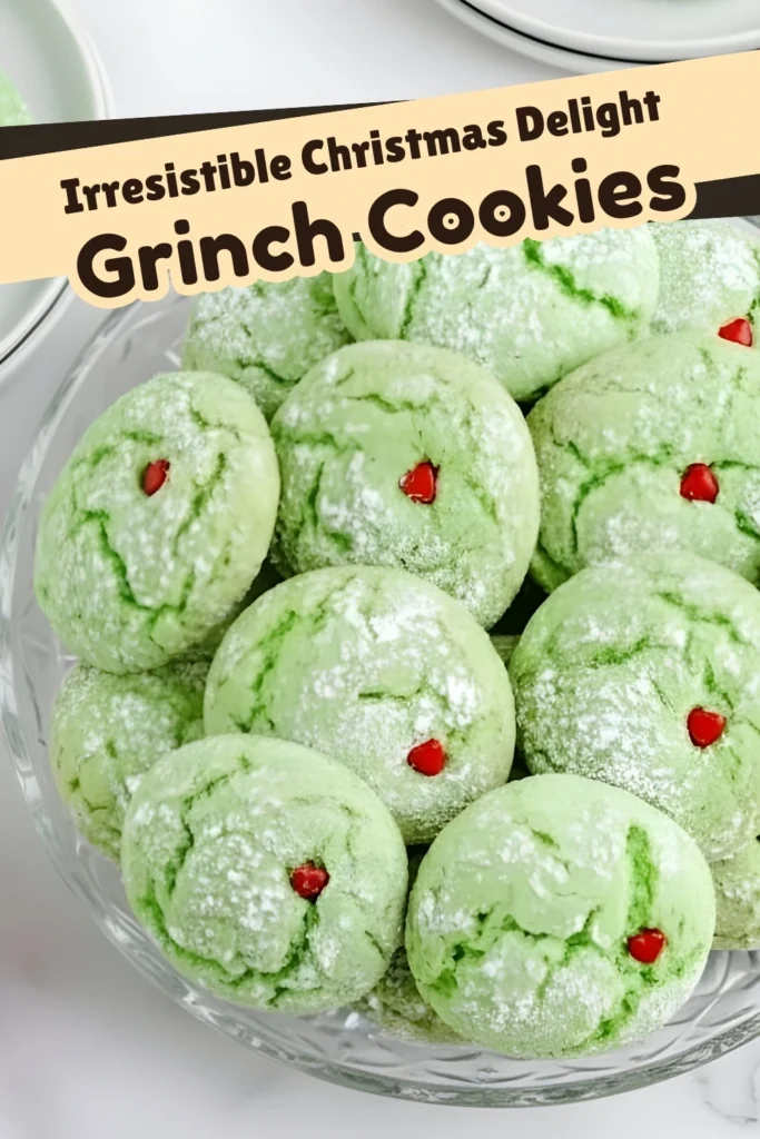 Easy Grinch Cookies displayed on a glass plate with powdered sugar and red heart sprinkles, labeled “Irresistible Christmas Delight” in the image text.