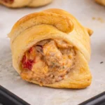 Sausage cream cheese crescent rolls baked until golden and filled with creamy sausage and tomatoes