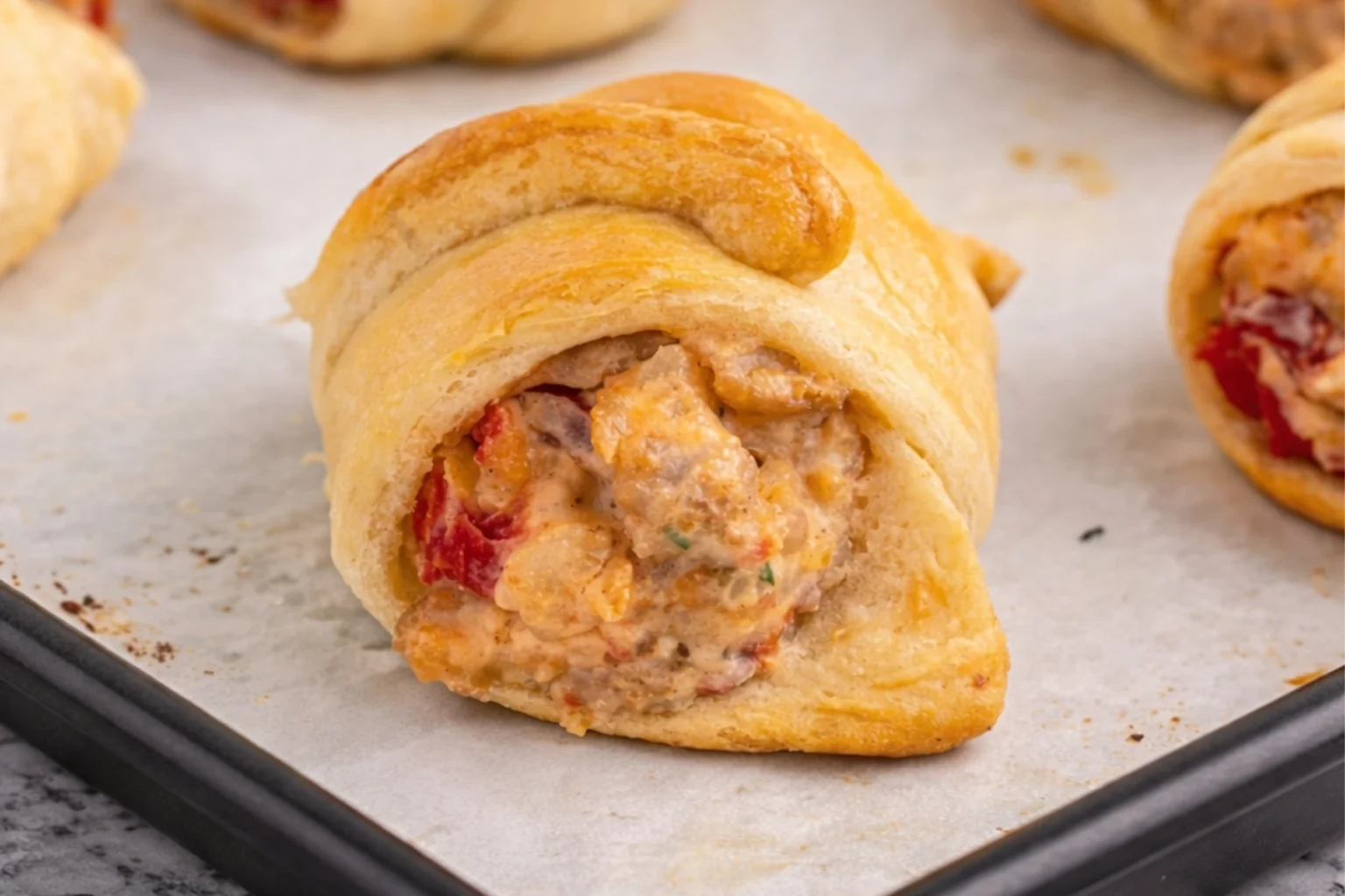 Sausage cream cheese crescent rolls baked until golden and filled with creamy sausage and tomatoes
