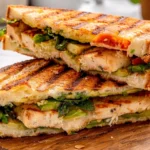 Grilled Chicken and Avocado Panini with Fresh Veggies and Sesame Bread