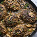 Old Fashioned Salisbury Steak patties in mushroom gravy cooked in a skillet