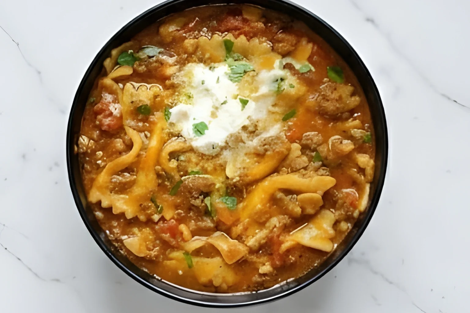 Delicious homemade lasagna soup with ground beef, pasta, and melted cheese