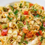 Creamy chicken pasta primavera with fresh vegetables and herbs
