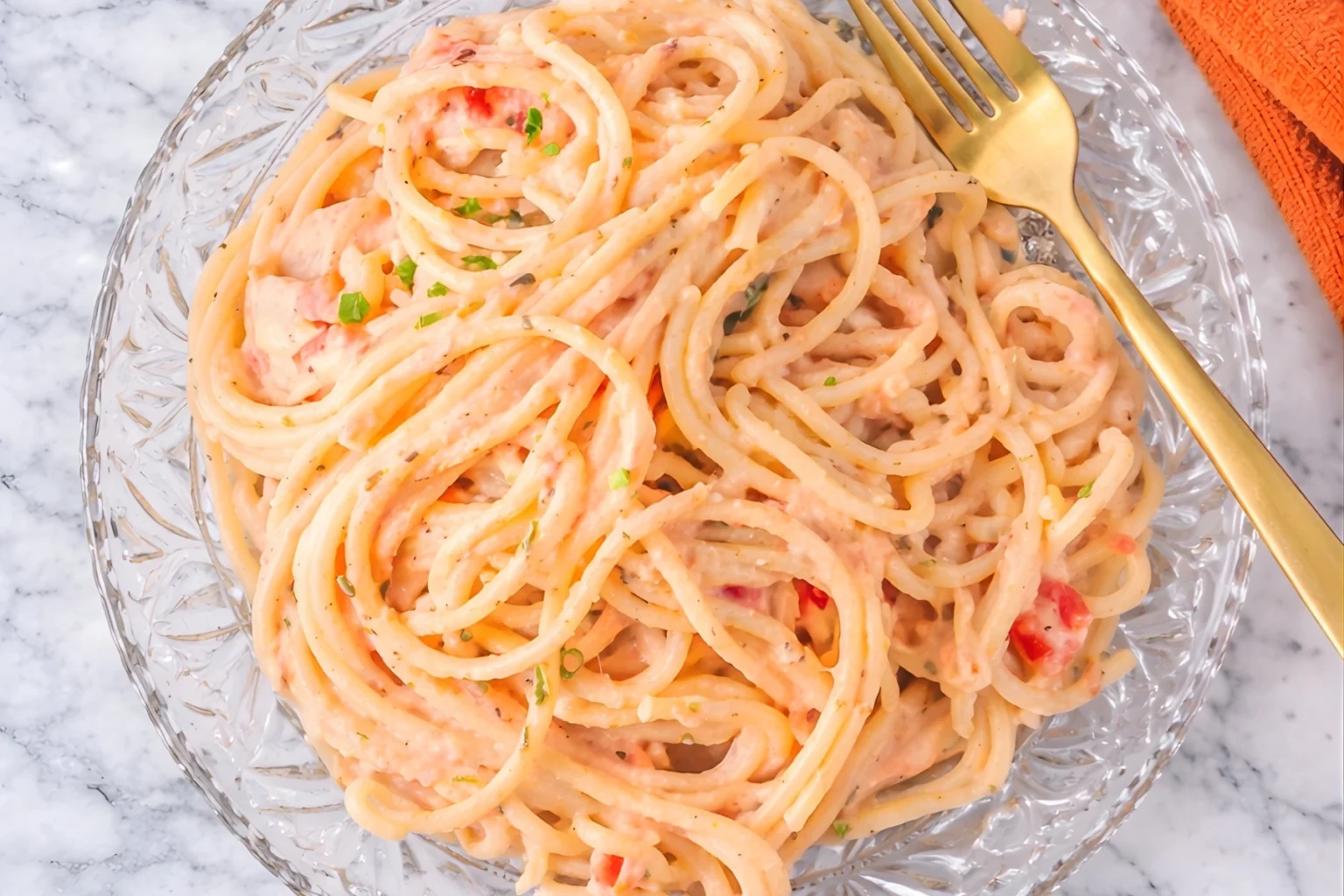 Creamy Italian pink sauce pasta with spaghetti in a tomato cream sauce on a glass plate