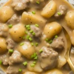 Creamy steak and potato soup in a bowl with tender beef chunks and golden potatoes topped with fresh chives
