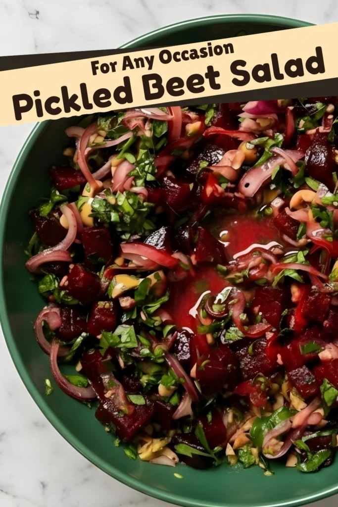 Colorful pickled beet salad with fresh herbs, onions, and pistachios in a green bowl.