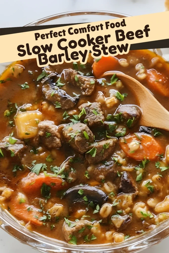 Bowl of Slow Cooker Beef Barley Stew filled with tender beef chunks, carrots, potatoes, and mushrooms in a thick, hearty broth garnished with fresh herbs.