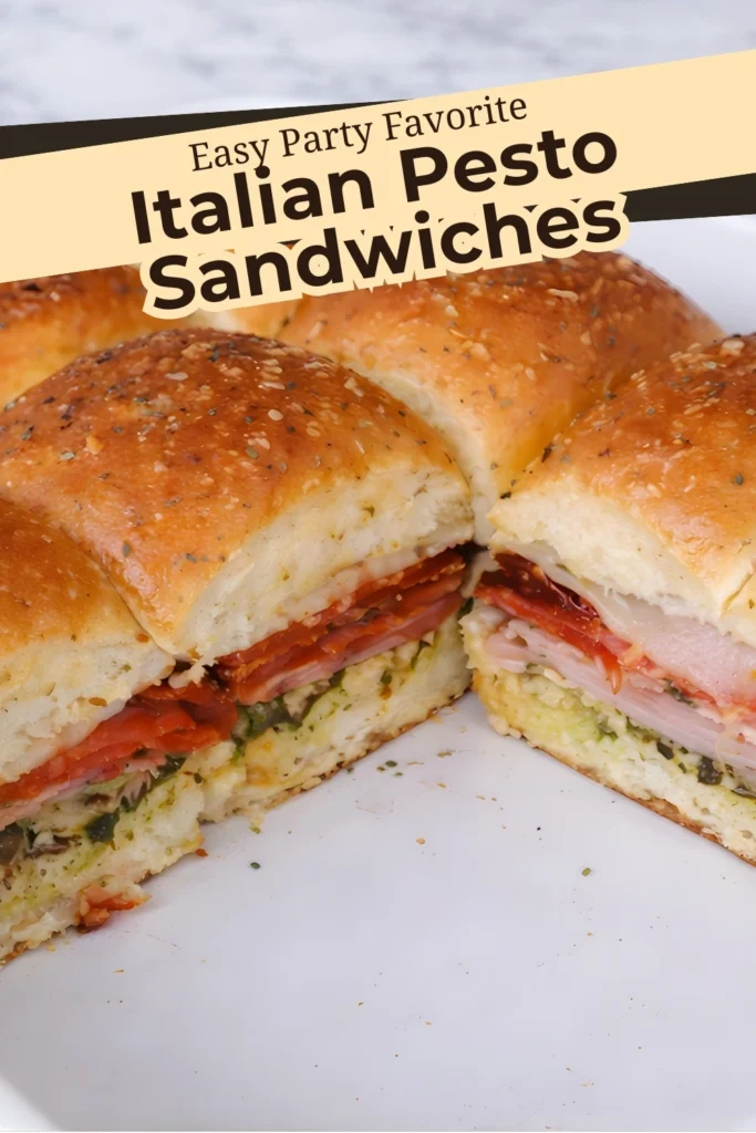 Italian pesto sandwiches sliced open showing ham salami pepperoni provolone cheese and pesto on soft baked rolls
