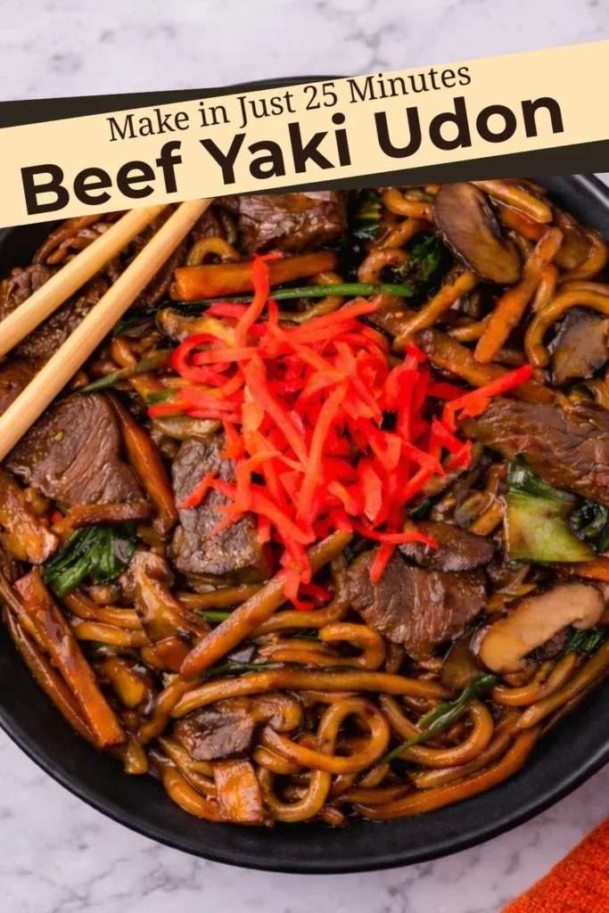 Beef yaki udon in a black bowl with red pickled ginger and text overlay that reads “Make in Just 25 Minutes Beef Yaki Udon”
