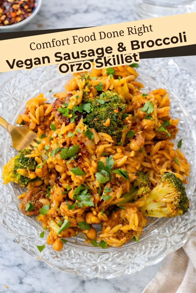 Vegan sausage and broccoli orzo skillet served on a clear plate with parsley and red pepper flakes, text overlay reads Comfort Food Done Right