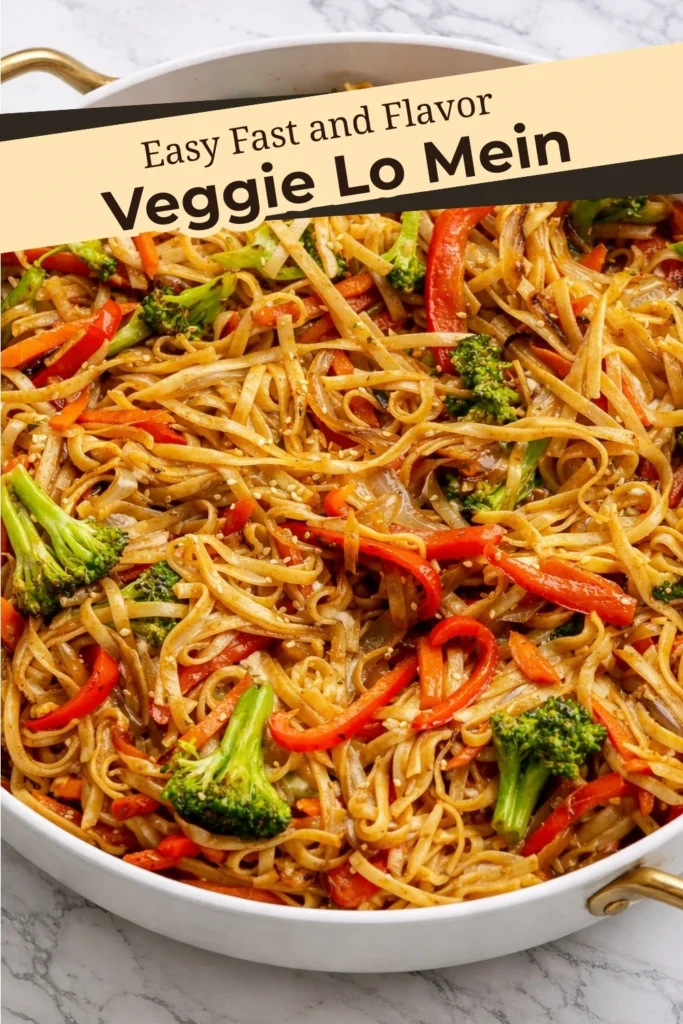 Veggie Lo Mein noodles with broccoli carrots and red bell peppers in a skillet with sesame sauce