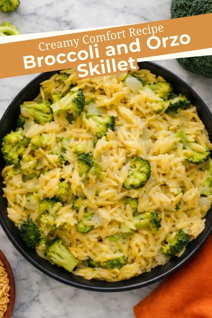 Creamy broccoli and orzo skillet with cheddar cheese in a black pan and text overlay