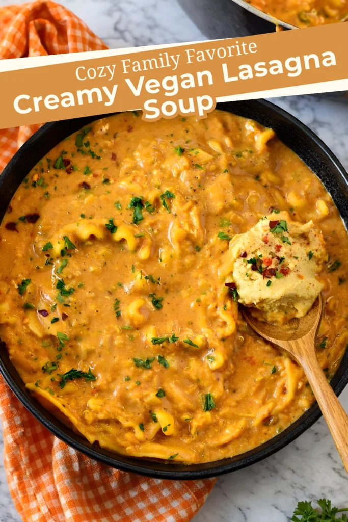 Bowl of creamy vegan lasagna soup with cashew topping and Cozy Family Favorite text overlay
