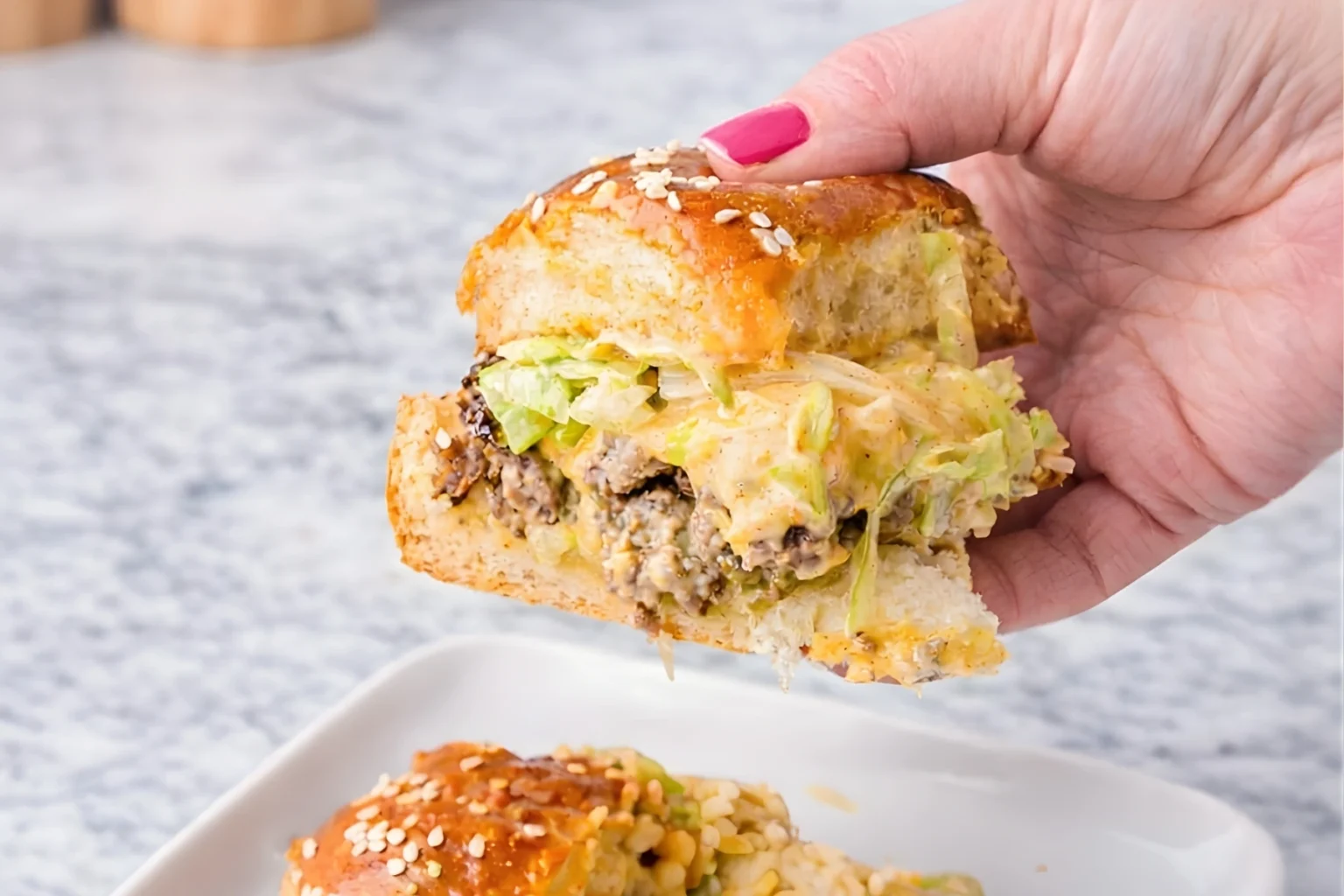 Big Mac Slider with Lettuce, Beef, and Cheese in Hand