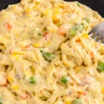 Creamy chicken pot pie casserole with noodles vegetables and cheese