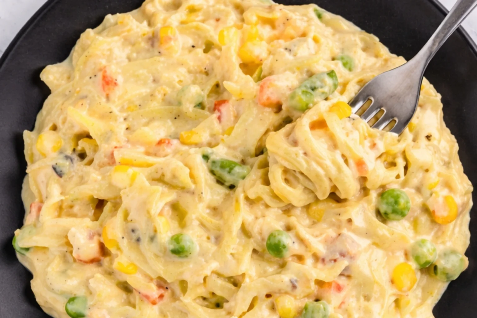 Creamy chicken pot pie casserole with noodles vegetables and cheese