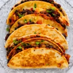 Crispy Black Bean Tacos with Fresh Cilantro and Cheesy Filling