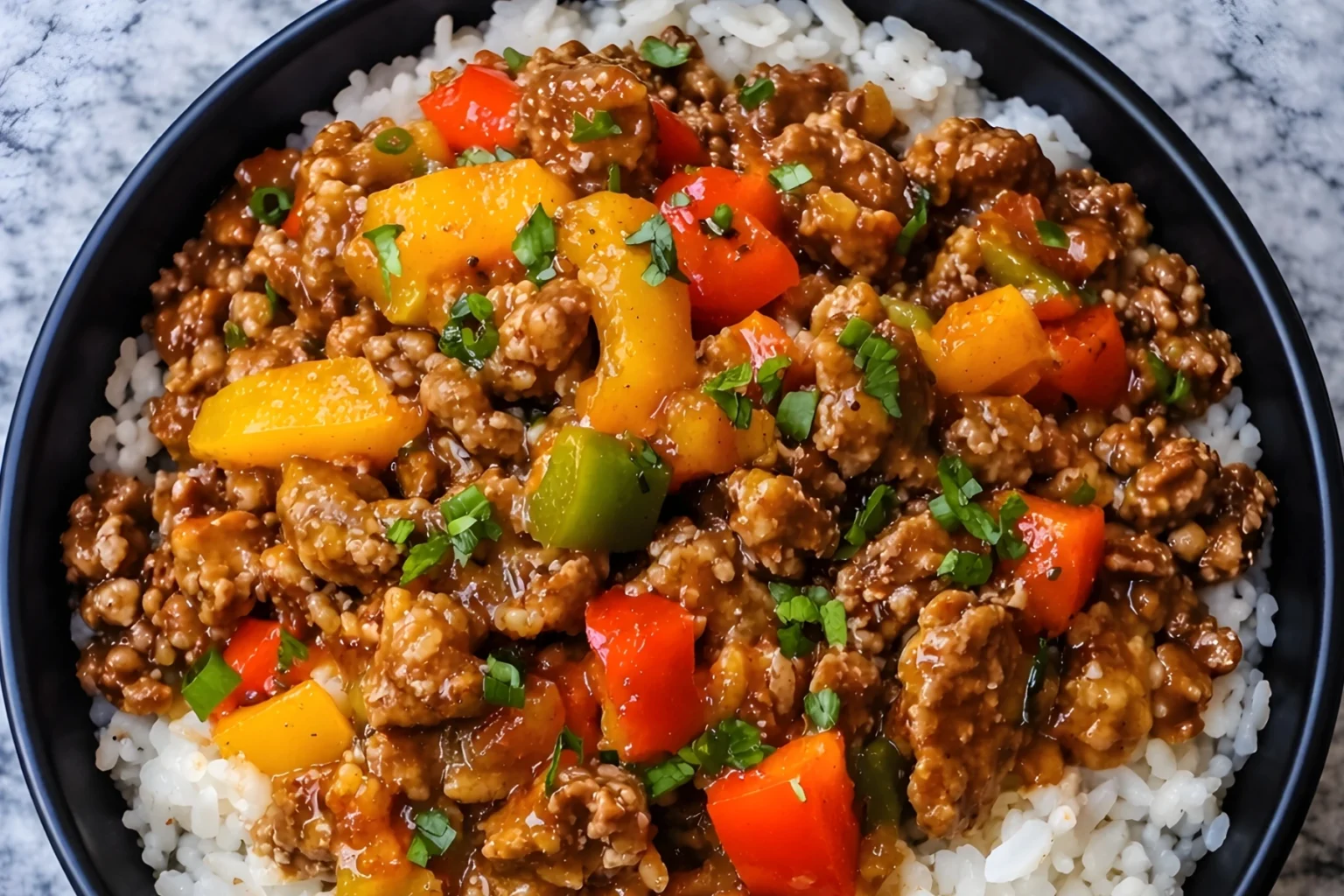 Beef and pepper rice bowl with colorful bell peppers over white rice