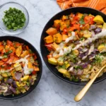 Roasted vegetable quinoa bowl topped with tahini sauce