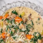 Italian sausage and white bean soup with kale carrots potatoes and parmesan in a creamy broth