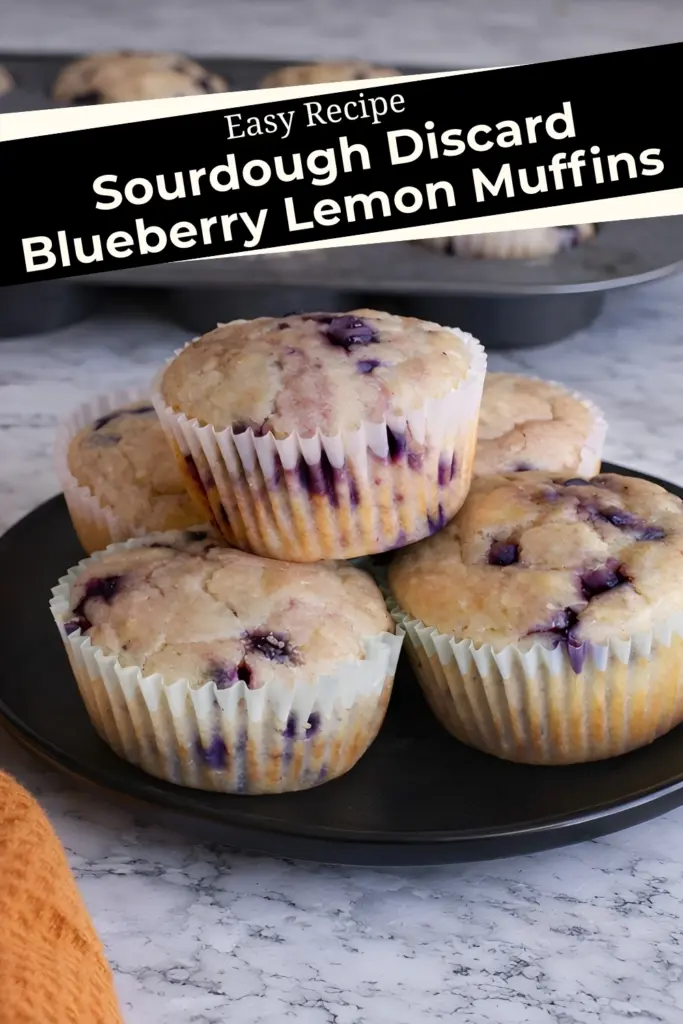 Easy recipe for sourdough discard blueberry lemon muffins on black plate with purple streaks