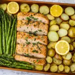 Sheet pan salmon with roasted asparagus, baby potatoes, and fresh lemon slices