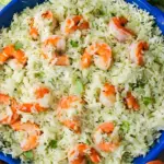 Cilantro Lime Shrimp & Rice in a blue skillet with fluffy white rice, pink shrimp, fresh cilantro, and lime on a marble surface