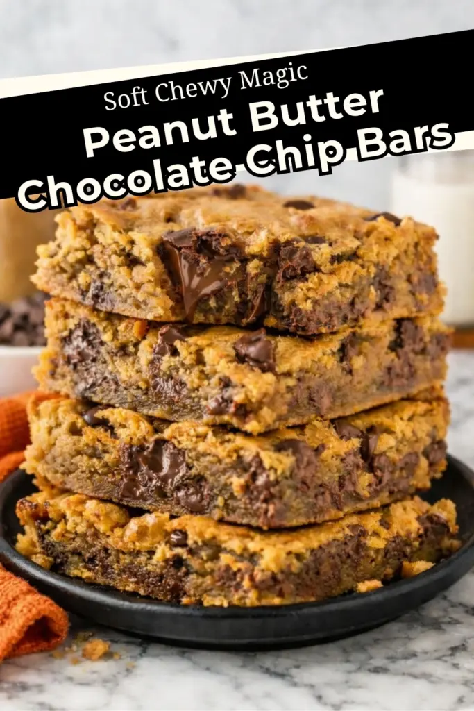 Peanut Butter Chocolate Chip Bars stacked on a plate with melted chocolate chunks and soft chewy texture