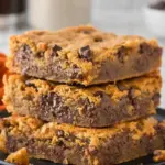 Peanut Butter Chocolate Chip Bars stacked on a plate showing soft chewy texture with melted chocolate chips