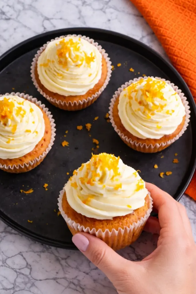 Overhead View of Orange Blossom Cupcakes with Frosting and Orange Zest