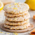 Lemon Oatmeal No Bake Cookies stacked with glaze and lemon zest on marble countertop