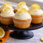 Cheesecake Stuffed Lemon Cupcakes with Creamy Frosting and Fresh Lemon Slices