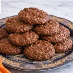 No bake chocolate oatmeal cookies stacked on decorative plate
