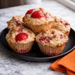 Strawberry Oatmeal Muffins on Black Plate with Fresh Strawberries