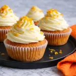 Orange Blossom Cupcakes with Creamy Frosting on Black Plate